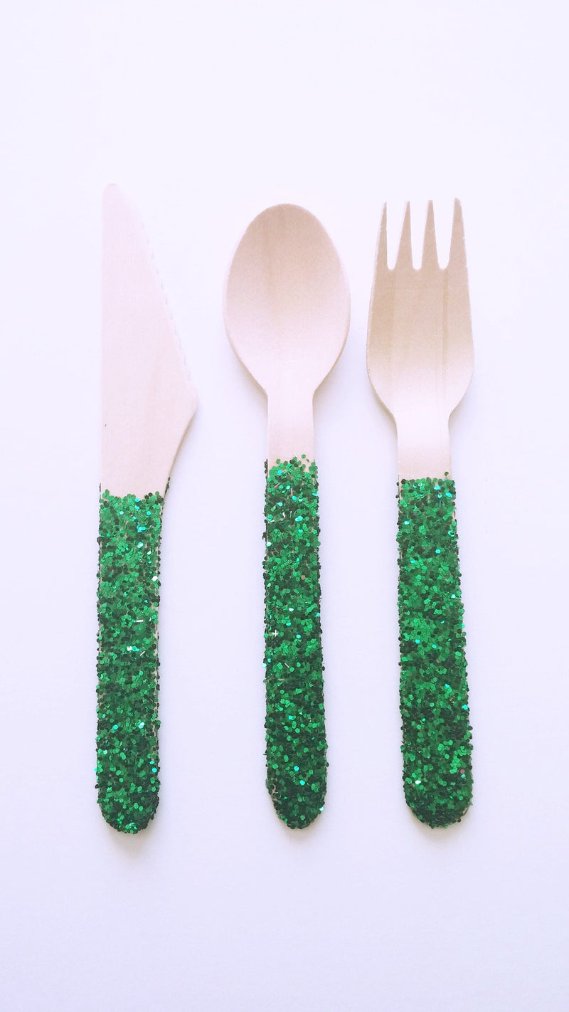 Green glitter wooden forks, spoons and knives for a dinner party