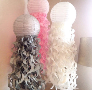 paper jellyfish lanterns in light pink, white and gray